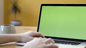 Person Working on Laptop with Green Screen | Free Stock Video Footage