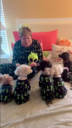 Mom Reads a Bedtime Story to her Dogs in Matching Alien Pajamas