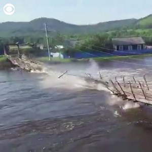 BRIDGE COLLAPSE: Witness video captures the moment a suspension bridge in Russia suddenly burst and collapsed as a truck was driving across the heavily flooded waters. | CBS News