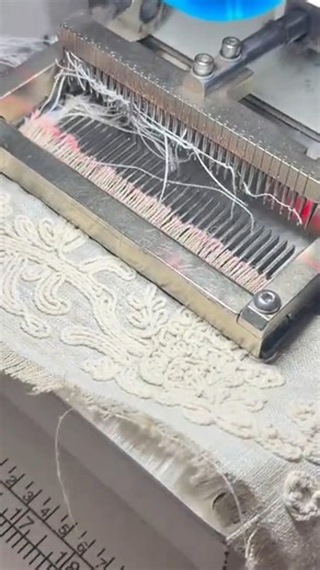 sewing an intricate cream floral lace pattern using a professional multi needle embroidery machine